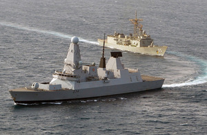 Royal Navy Type 45 destroyer HMS Diamond, in the foreground, exercises with the Royal Australian Navy Adelaide Class guided missile frigate HMAS Melbourne