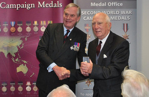 Lord Astor of Hever (left) presents an award to a Second World War veteran [Picture: Crown copyright]