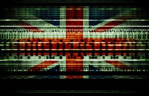 British Union Jack blended with binary numbers and data streams representing data usage, cyber crime, national security