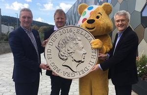 Pudsey the bear with Exchequer Secretary to the Treasury Andrew Jones, The Royal Mint's Adam Lawrence and Jonathan Rigby from BBC Children in Need.