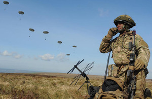 A 16 Air Assault Brigade signaller on the radio as troops make an airborne insertion during Excercise Joint Warrior
