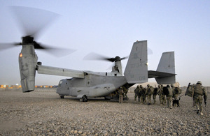 Members of II Squadron RAF Regiment and the US Marine Corps board a US Osprey aircraft at Camp Bastion in Helmand province