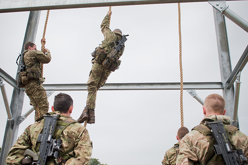 Royal Marines reservists climb a training frame