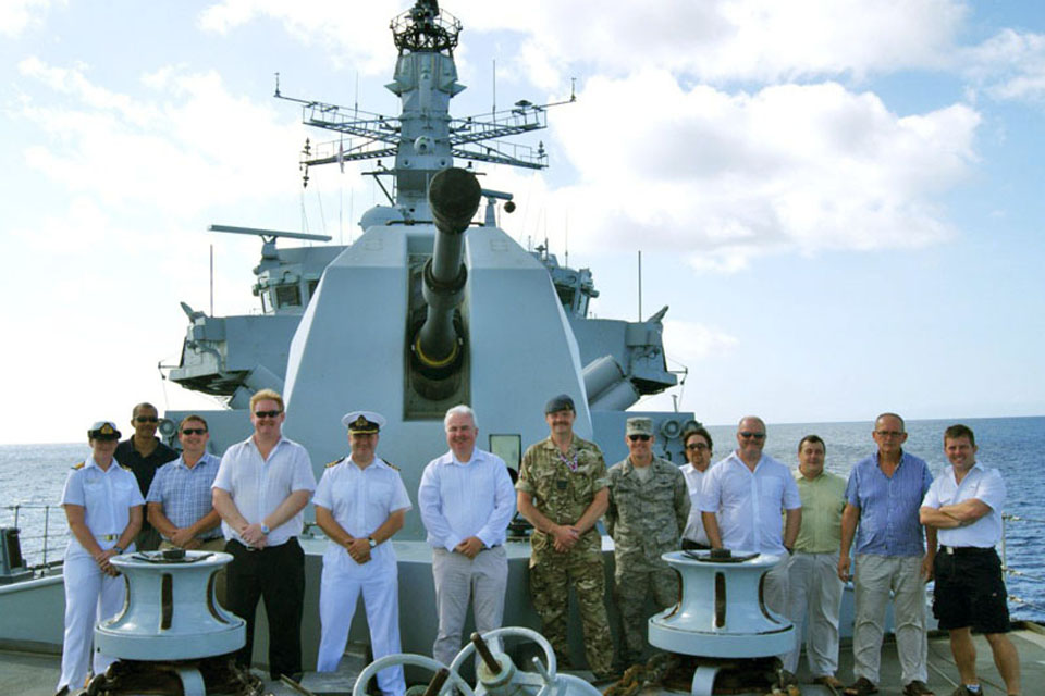 Key figures from the Ascension Island community on board HMS Montrose with the ship's Commanding Officer