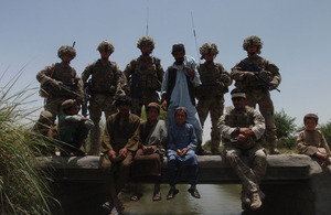 British and Afghan Service personnel with local villagers on the new bridge