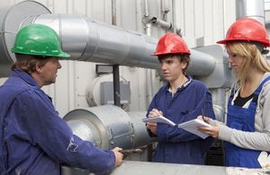 Apprentice engineers being taught on the job