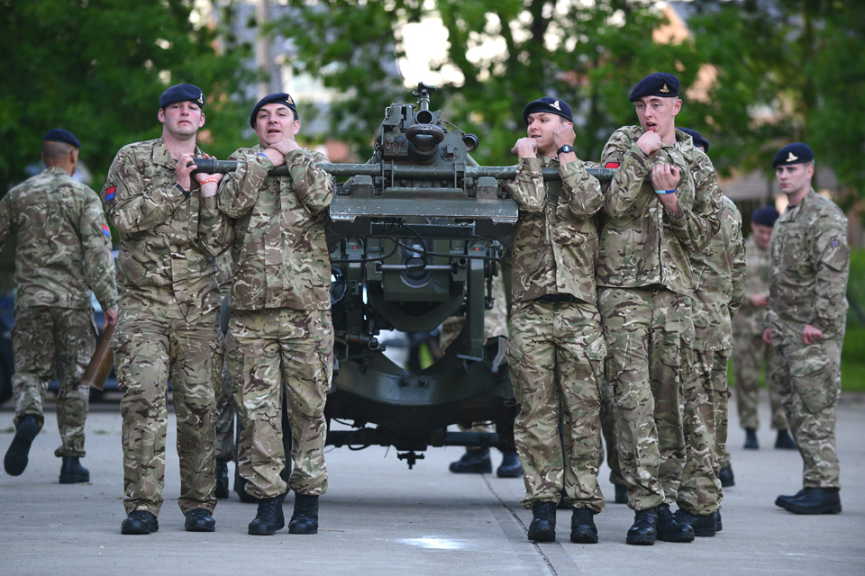 TA soldiers manoeuvre their 105-millimetre light gun into position