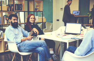 Group of young professionals collaborating around a table
