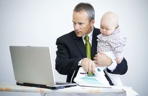 A businessman tries to balance home and work duties.