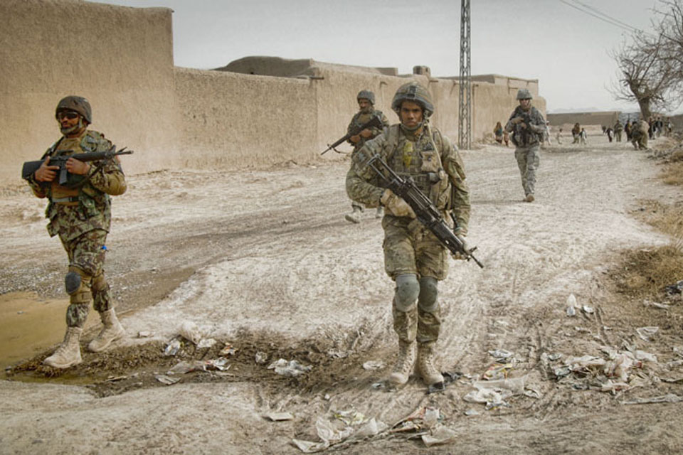 Members of 15 Squadron RAF Regiment and the Afghan Air Force patrol through the village of Koshab  