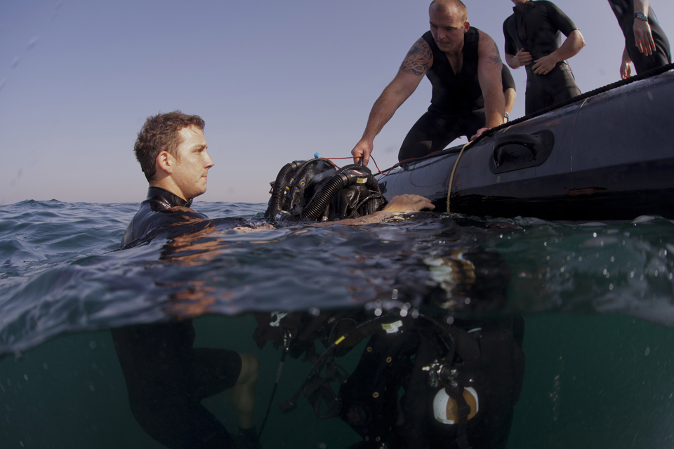 Able Seaman Diver Phil Barham assists Able Seaman Diver Thomas Long