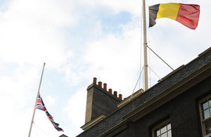 Belgian and UK flags at half-mast