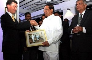 High Commissioner handing over Sri Lankan President a photograph of Her Majesty Queen Elizabeth the Second meeting Sri Lankan President.