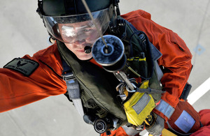 Royal Marines Corporal Justin Morgan operates a Search and Rescue helicopter's winch (library image)