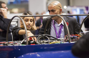 HYPED's Elisha Jhoti with a delegate, discussing the prototype Hyperloop