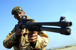 A soldier displays the new combat shotgun