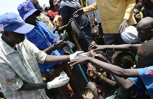 Children reach to have their fingers dipped in ink as part of a WFP/FAO food distribution supported by UK aid in Leer County, South Sudan. Picture: George Fominyen