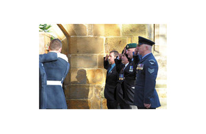 Veterans and serving personnel salute the coffin of Sir Rex Hunt