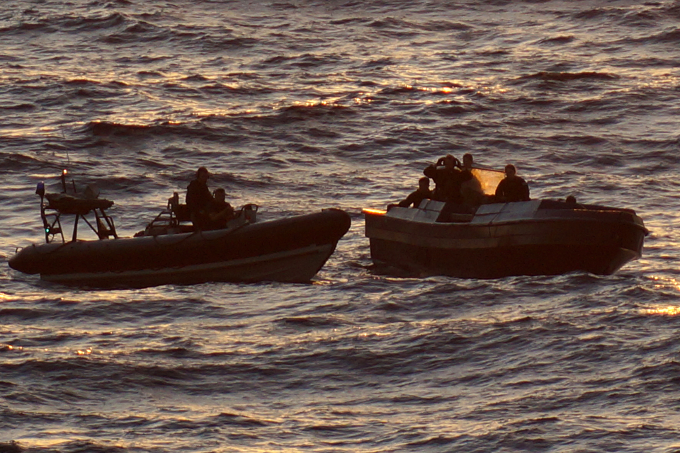 The 25-foot speedboat (right) seized by the United States Coast Guard and RFA Wave Knight