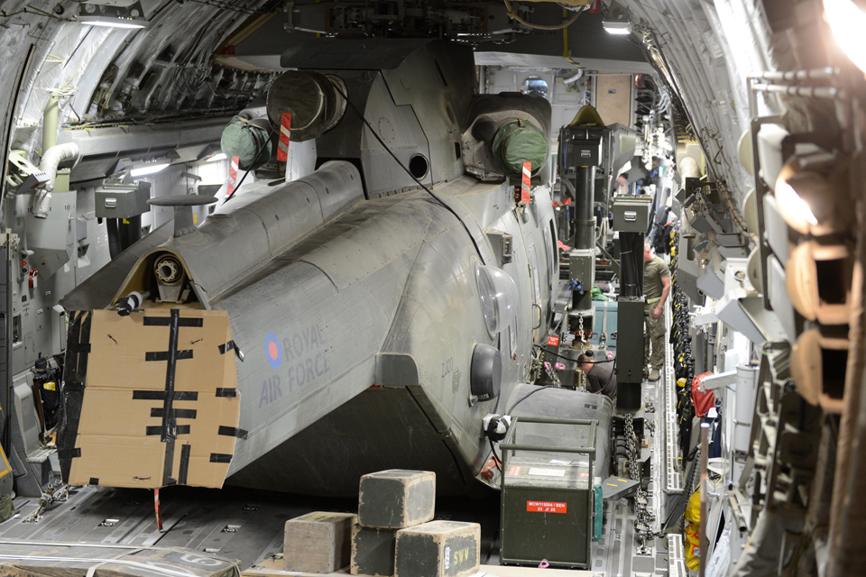 A Merlin helicopter is packed and secured into an RAF C-17