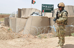 A Gurkha protects the gate at Checkpoint Noorzai during a visit