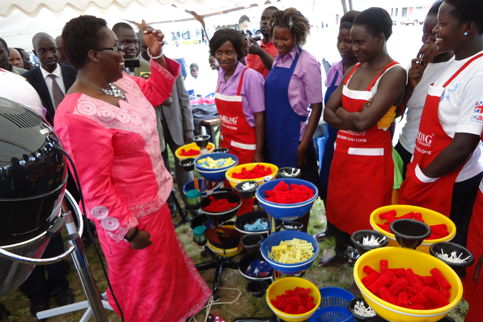 The Minister for Northern Uganda speaking to young women who trained as hairdressers. Picture: Lillian Akot/DFID