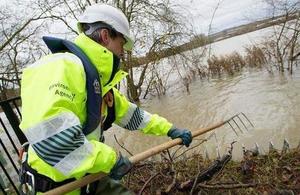 Environment Agency staff member clearing flood defences