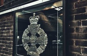 Photo of a picture frame containing a military badge. Photo: Michael Potts. All rights reserved.