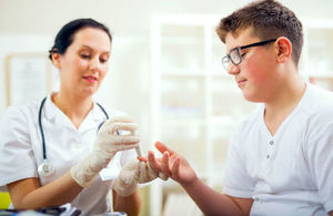 Testing blood glucose levels of person with diabetes