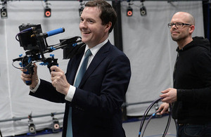 Chancellor holding a video camera in a filming studio