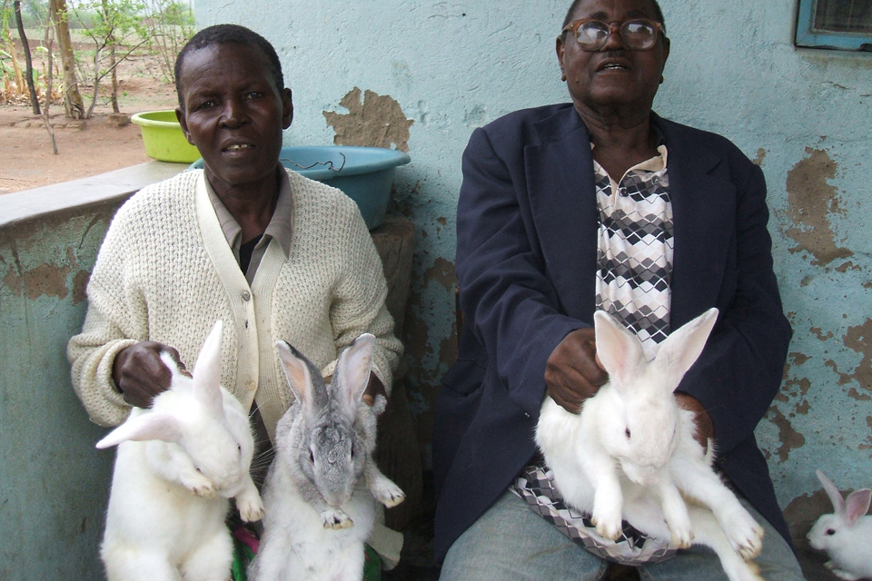 Gogo Kerina (left) and her husband holding some of her rabbits. Picture: DFID