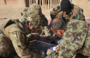 Afghan National Army officers plan which compounds to search with their British advisor prior to one of their most ambitious operations in the boundary areas between the districts of Nad 'Ali, Nahr-e Saraj, and Lashkar Gah