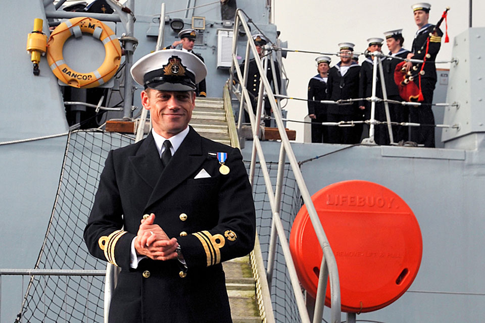 HMS Bangor's Commanding Officer, Lieutenant Commander Neil Marriott, steps onto dry land at Faslane after 120 days at sea