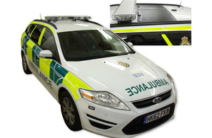 Green ambulance with solar roof panel.