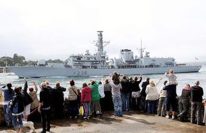 Family and friends wave to the crew of HMS Montrose as the ship leaves HM Naval Base Devonport