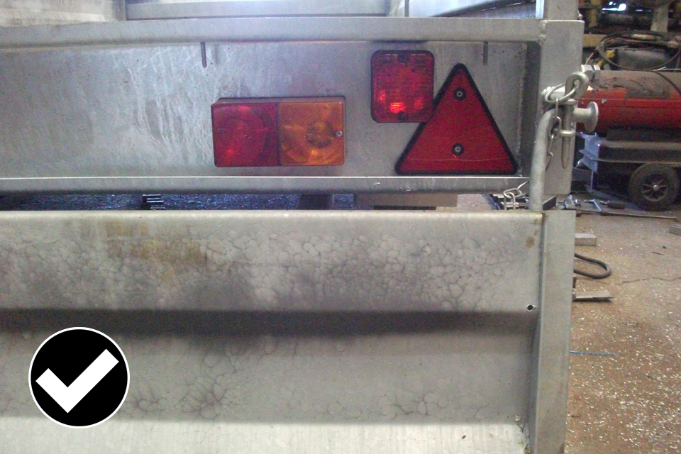 Allowed: the tailboard is dropped and the lamps are still fully visible and meet the required angle of visibility.