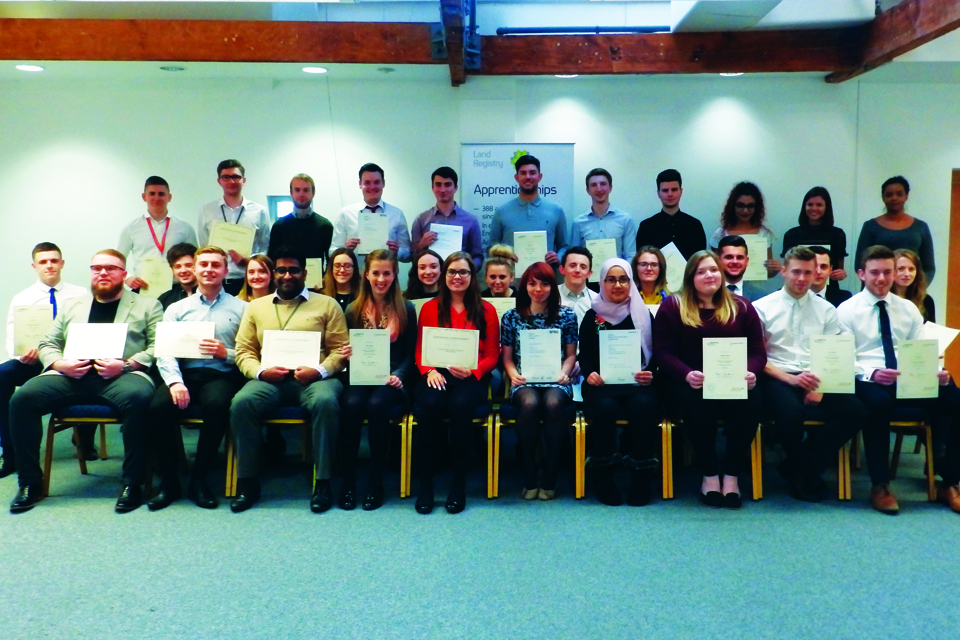 Picture of a group of apprentices holding the certificate for completing apprenticeship