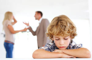 Arguing parents with child in foreground