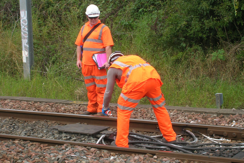 Railway workers fix severed cables