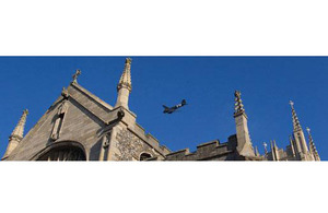 A vintage DC-3 Dakota aircraft flies over St Edmundsbury Cathedral