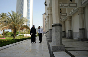 Two men walking along paved area