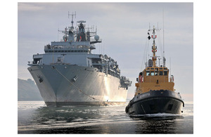 HMS Bulwark and a tug