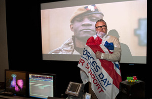Ray Winstone wrapped in an Armed Forces Day flag [Picture: Sergeant Jez Doak, Crown copyright]