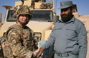 Warrant Officer Class 2 Terry Thompson, 1st Battalion The Princess of Wales's Royal Regiment, with the commander of Checkpoint Naeem in Babaji, Bor Agha