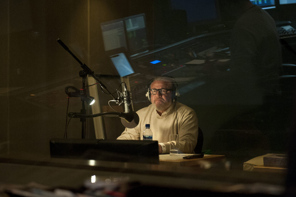 Ray Winstone sits in the recording room