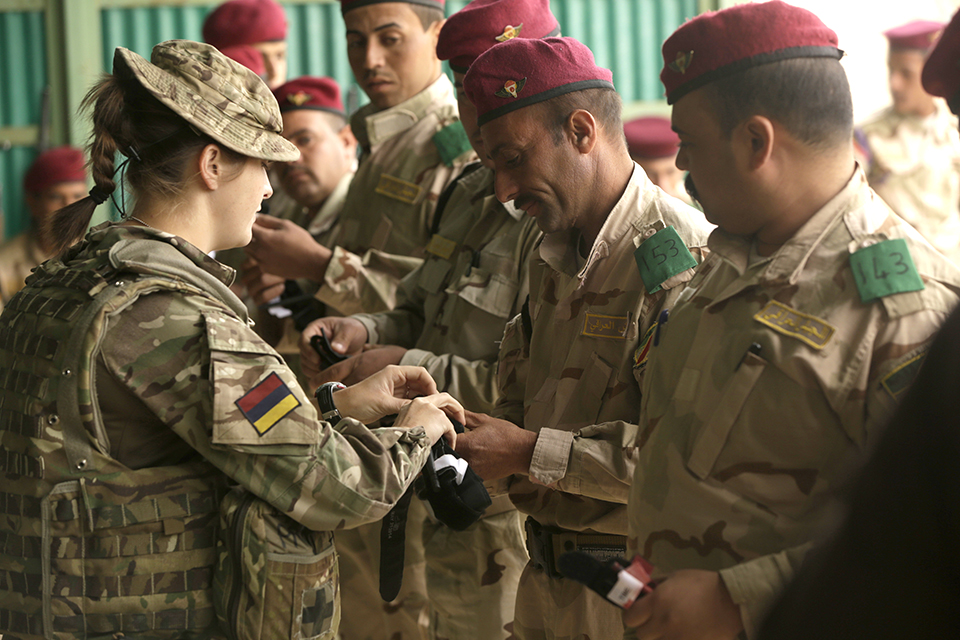 A British soldier with the Royal Army Medical Corps helps an Iraqi soldier prepare a tourniquet during a skills evaluation. Combined Joint Task Force - Operation Inherent Resolve Copyright. 