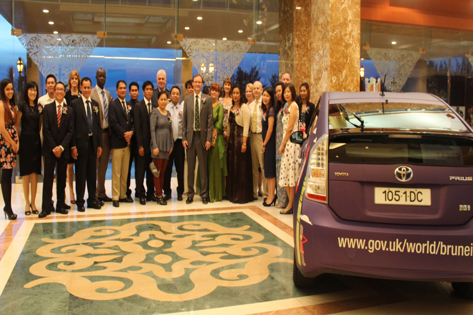 Members of staff of the British High Commission with the newly designed hybrid Prius