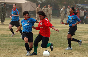 Afghanistan's national women's football team play a friendly match against a team of women from ISAF headquarters in Kabul