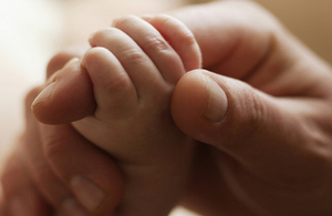 Parent holding baby's hand