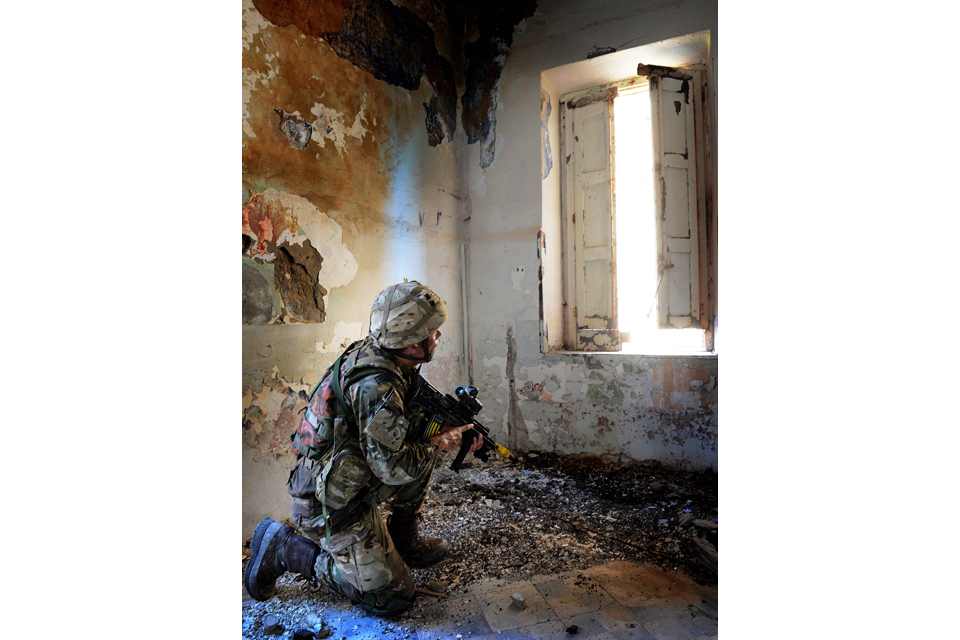 A Royal Marine keeps a watchful eye out for the enemy